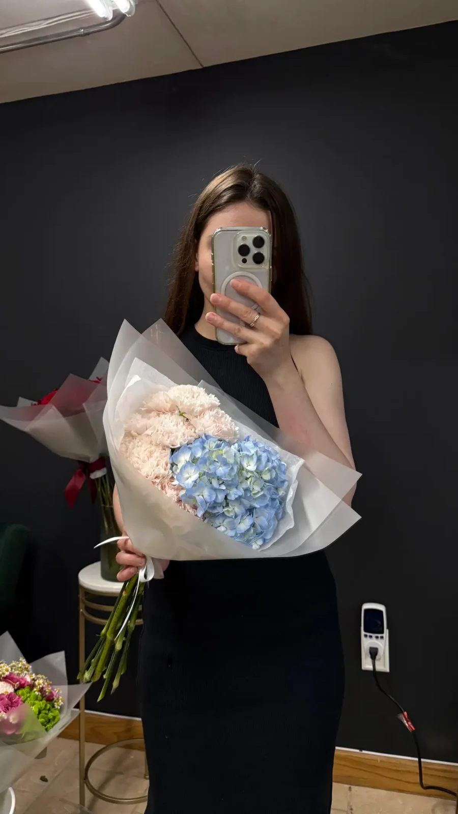 Blue hydrangea bouquet held by a Wildflower florist