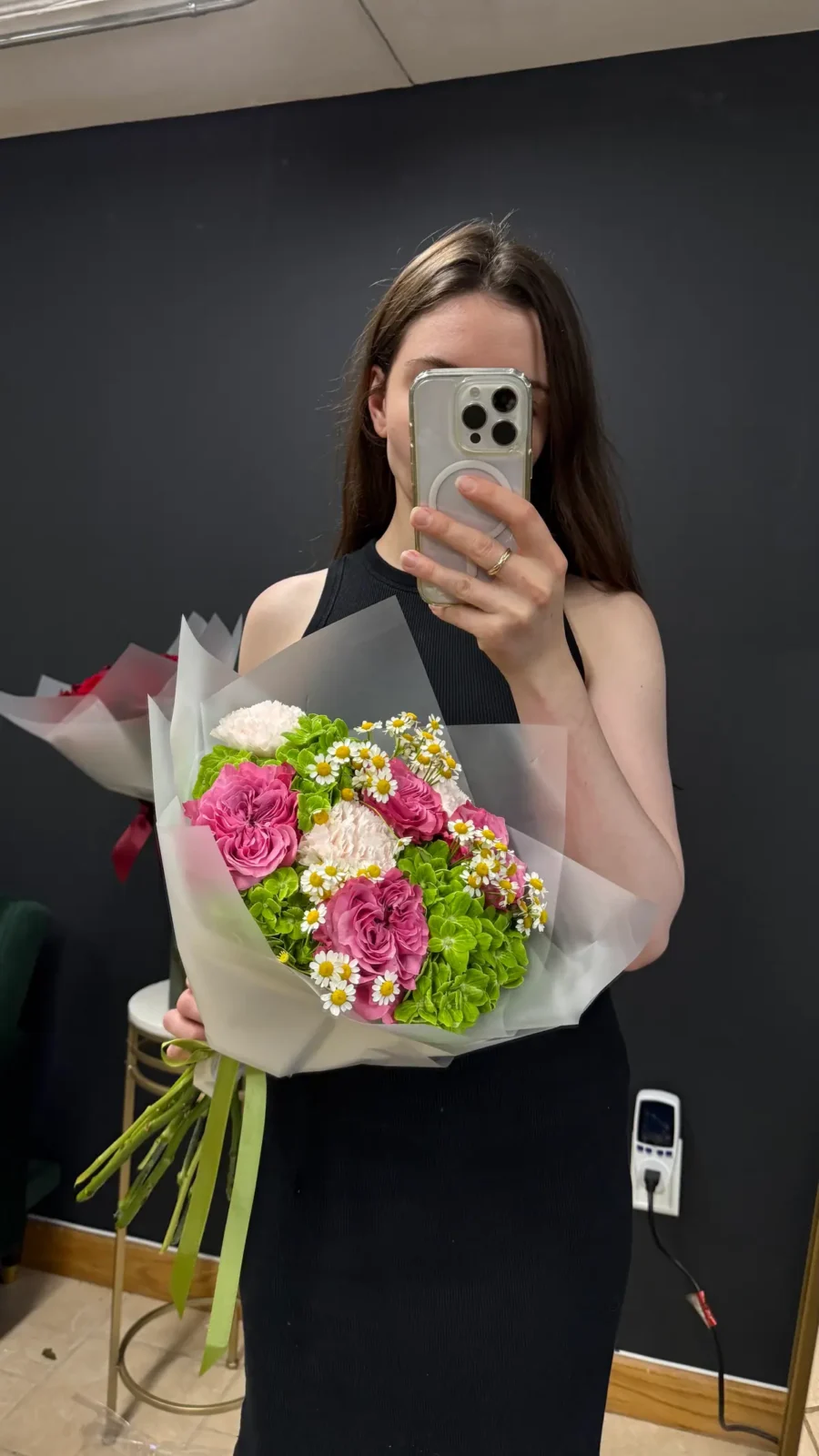 Bright pink and green mixed bouquet held by a Wildflower florist