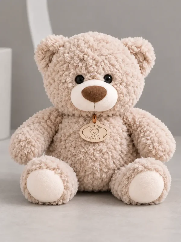 Beige plush teddy bear, 12 inches tall, sitting on a light table in the Boston Wildflower studio