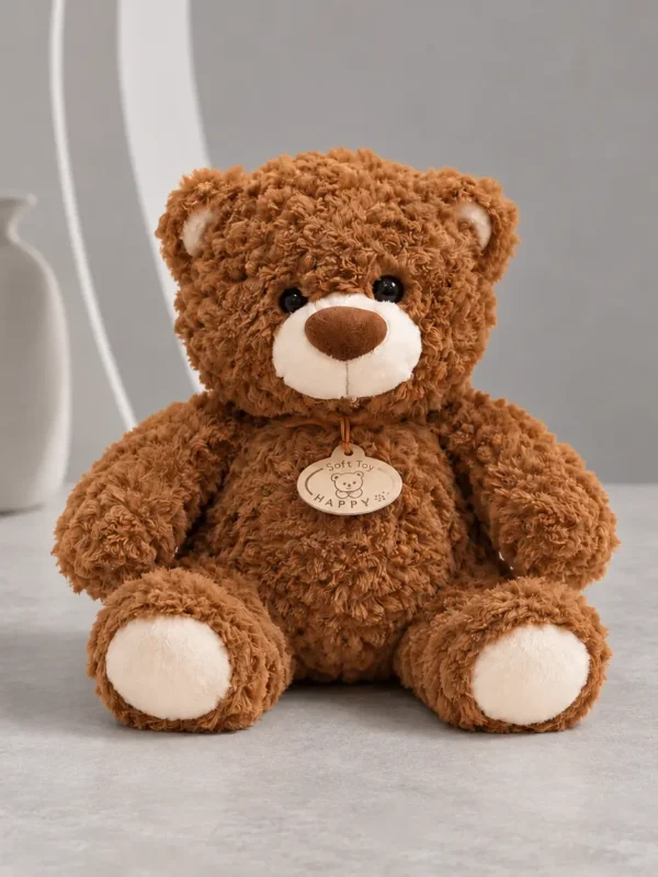 Brown plush teddy bear, 12 inches tall, sitting on a light table in the Boston Wildflower studio
